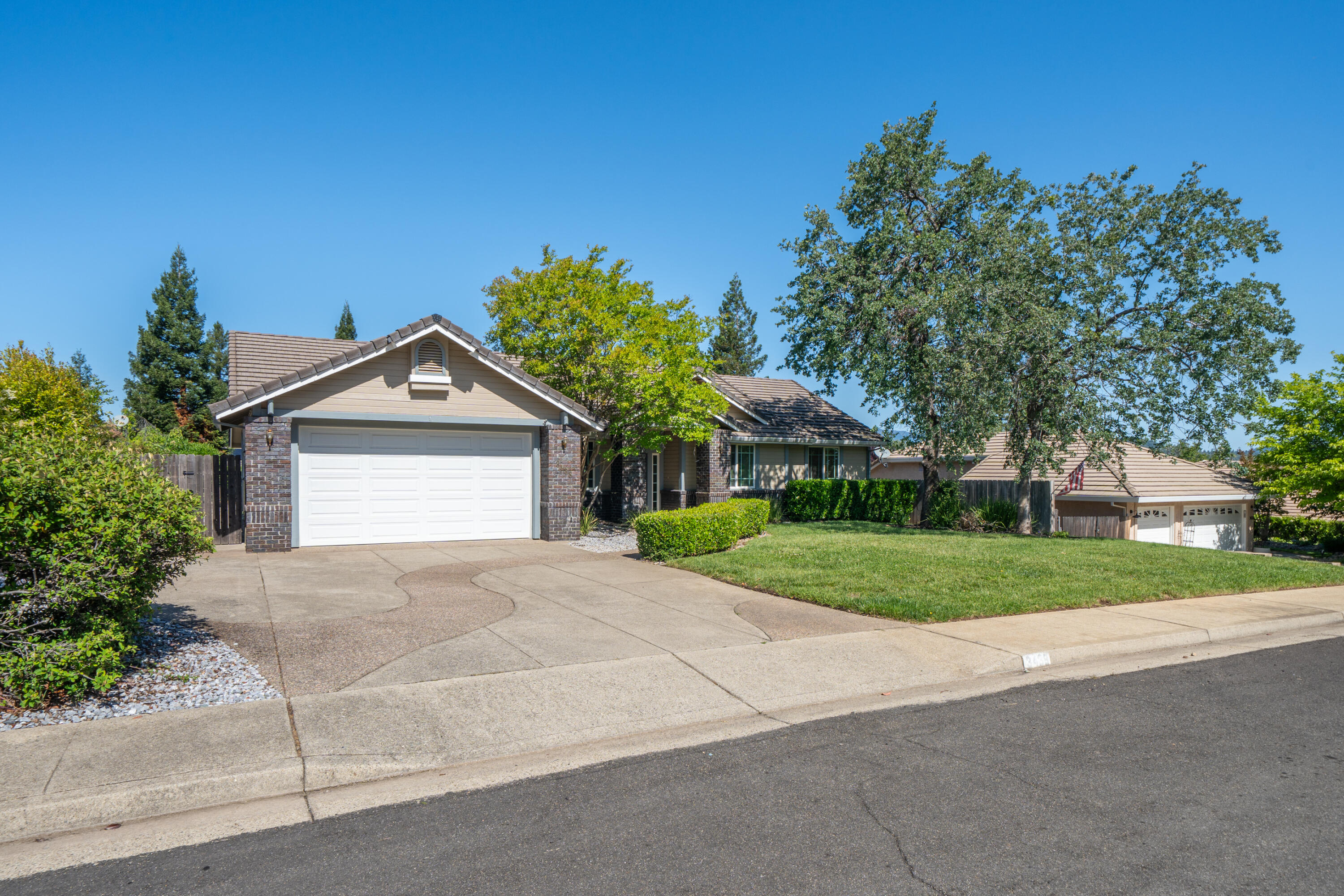 3438 Showboat Court Redding, CA 96003 - Photo 4 of 63 a front view of a house with a yard and garage