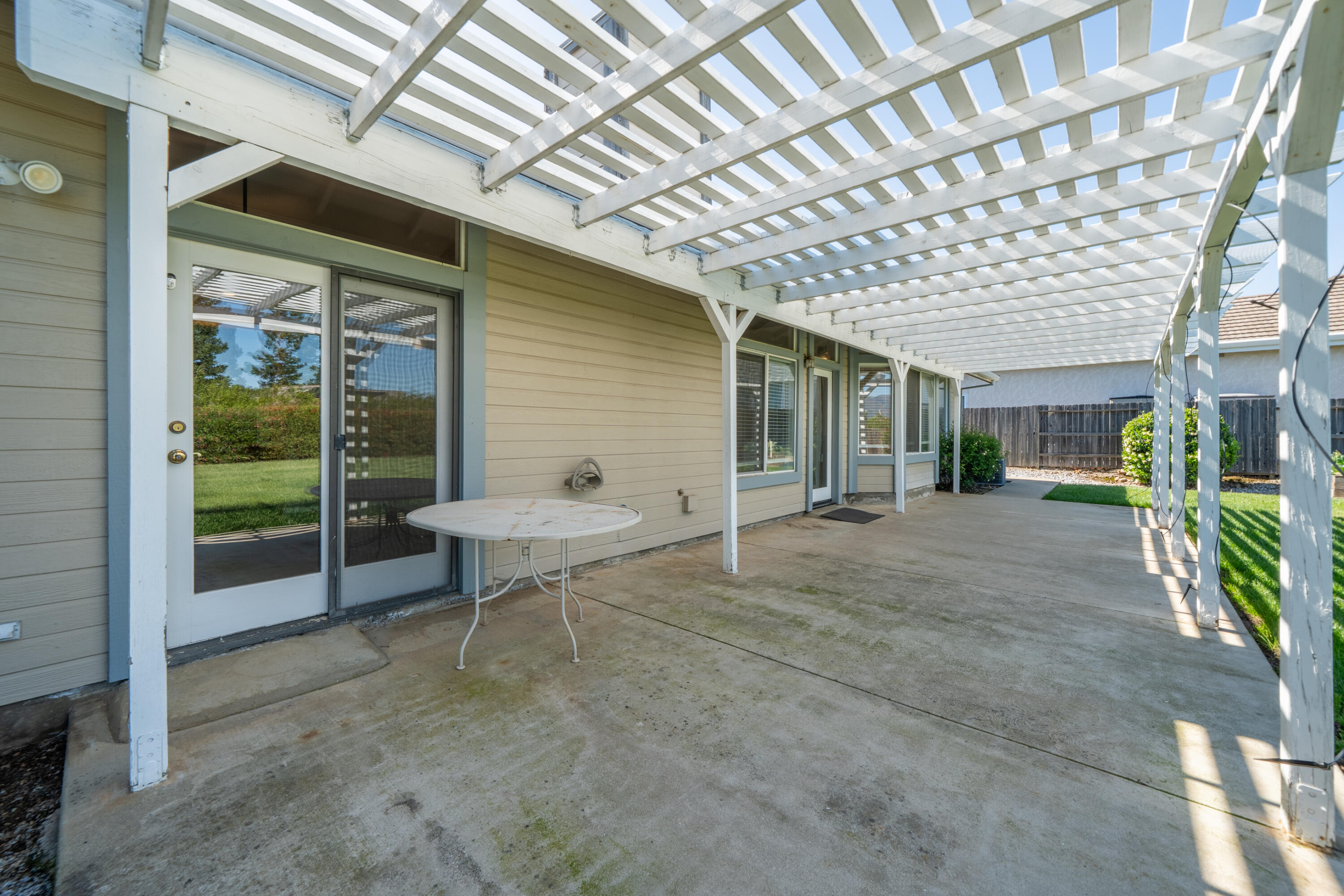 3438 Showboat Court Redding, CA 96003 - Photo 44 of 63 a view of a patio with table and chairs and potted plants