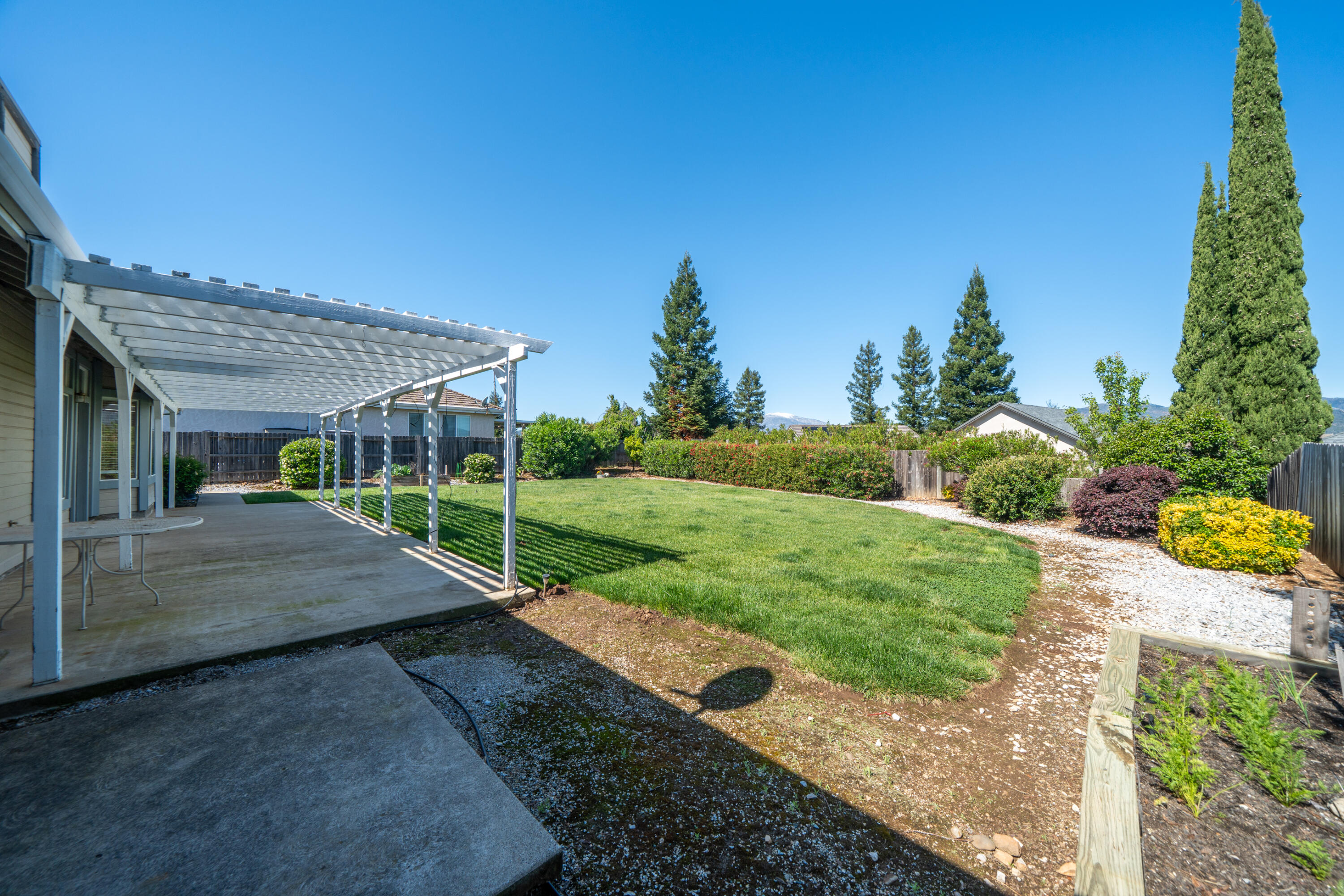3438 Showboat Court Redding, CA 96003 - Photo 45 of 63 a view of a house with backyard