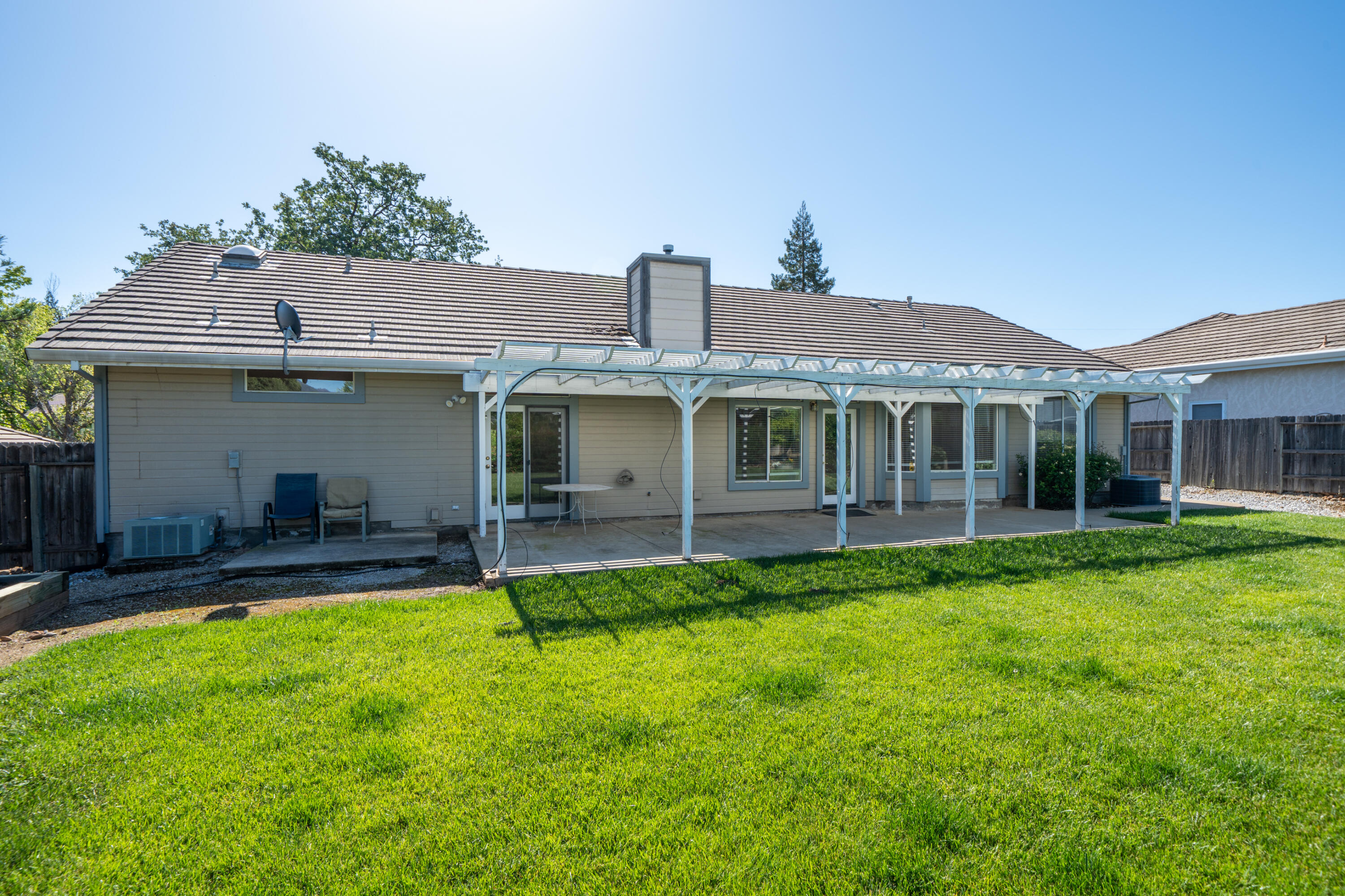 3438 Showboat Court Redding, CA 96003 - Photo 46 of 63 a front view of a house with a yard