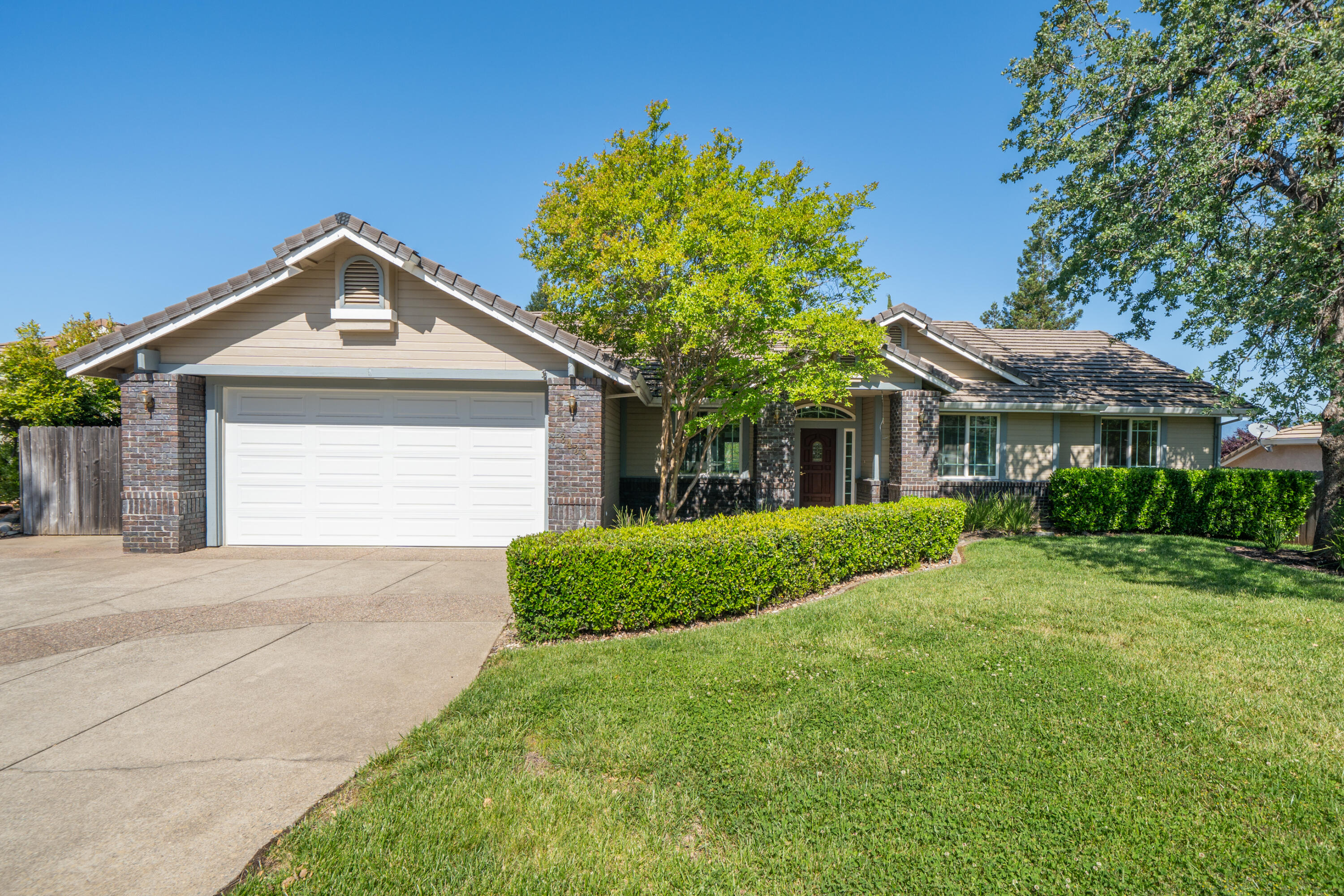 3438 Showboat Court Redding, CA 96003 - Photo 6 of 63 a front view of a house with a yard and garage