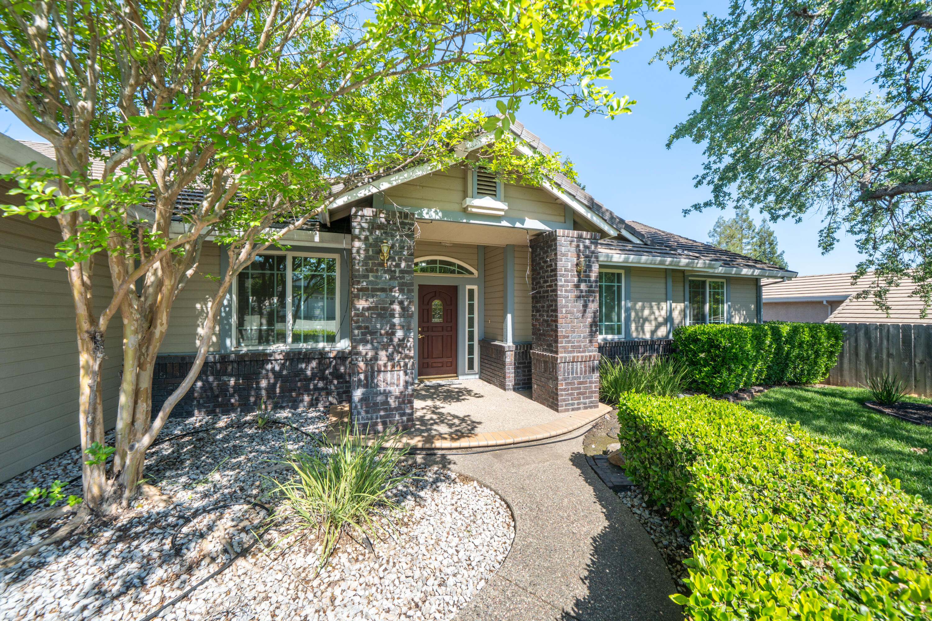 3438 Showboat Court Redding, CA 96003 - Photo 7 of 63 a view of a house with backyard sitting area and garden