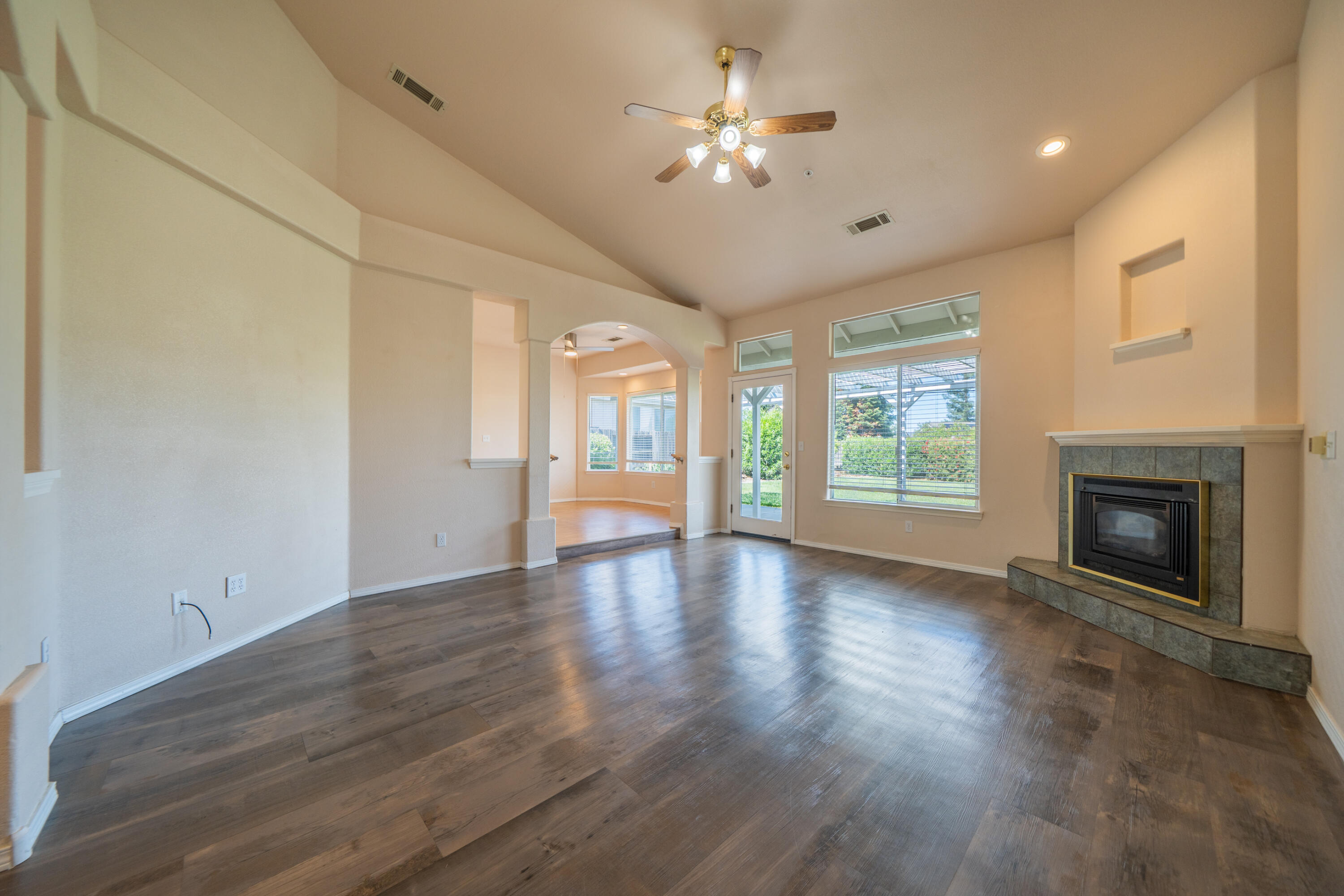 3438 Showboat Court Redding, CA 96003 - Photo 10 of 63 a view of an empty room with a fireplace and a window