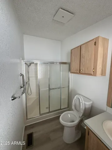 a bathroom with a toilet and a shower