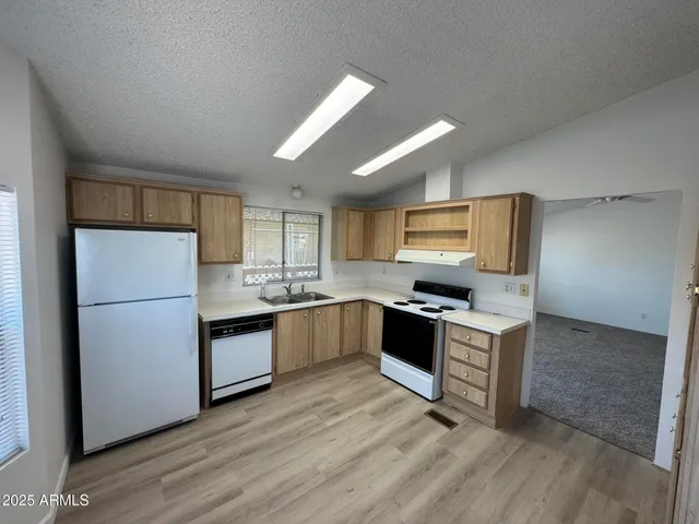 a kitchen with granite countertop a refrigerator and a stove