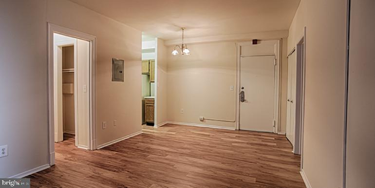 3900 Chestnut Street, Unit 0B907 Philadelphia, PA 19104 - Photo 4 of 13 a view of an empty room with wooden floor and a bathroom