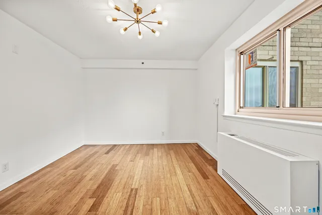 a view of a room with wooden floor and fan