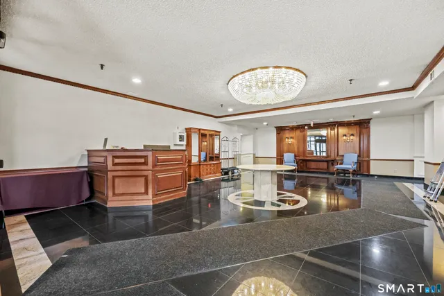 a view of a dining room with furniture a chandelier and wooden floor
