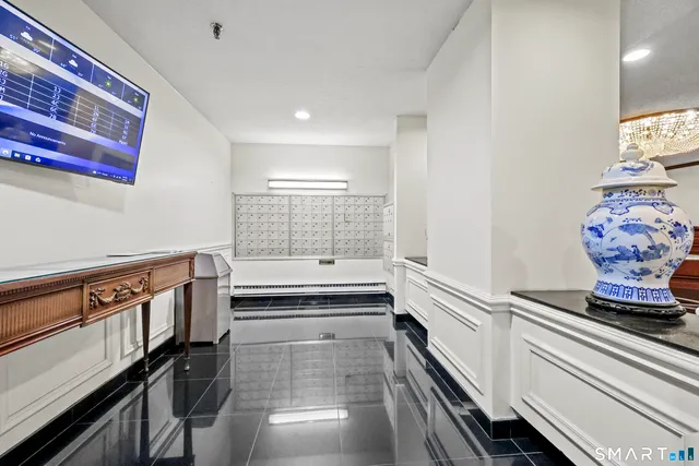 a hallway with white cabinets and stove