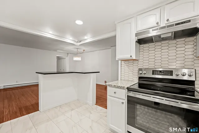 a kitchen with cabinets and steel stainless steel appliances