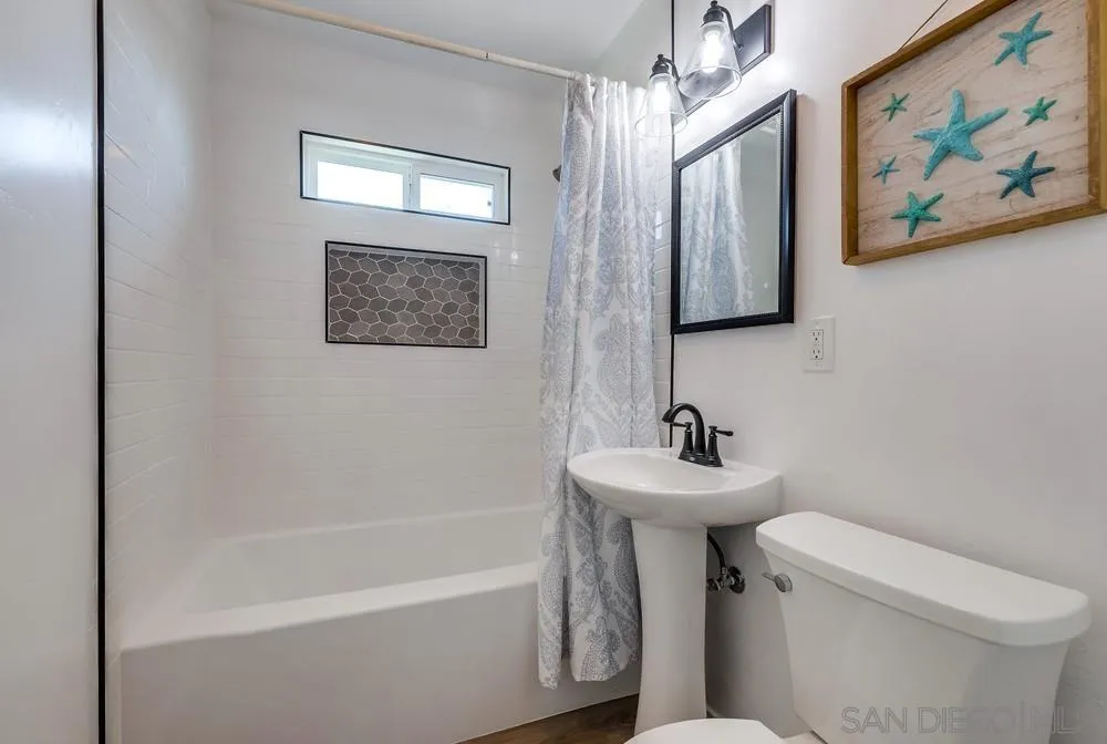9136 Northcote Road Santee, CA 92071 - Photo 11 of 33 a bathroom with a sink mirror and a toilet