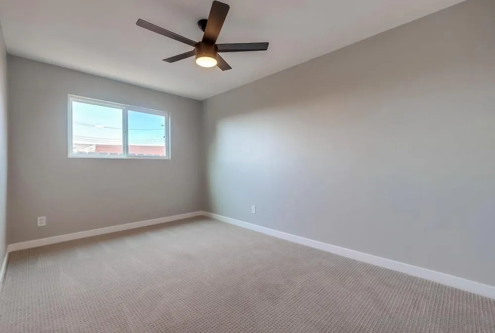 9136 Northcote Road Santee, CA 92071 - Photo 12 of 33 an empty room with a window and a fan