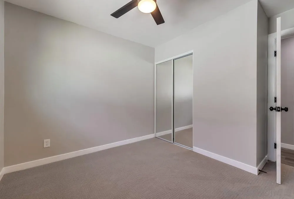 9136 Northcote Road Santee, CA 92071 - Photo 14 of 33 an empty room with a ceiling fan and a window