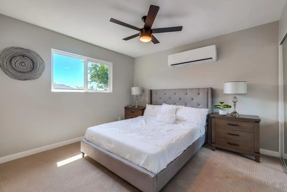 9136 Northcote Road Santee, CA 92071 - Photo 17 of 33 a bedroom with a bed and a chandelier