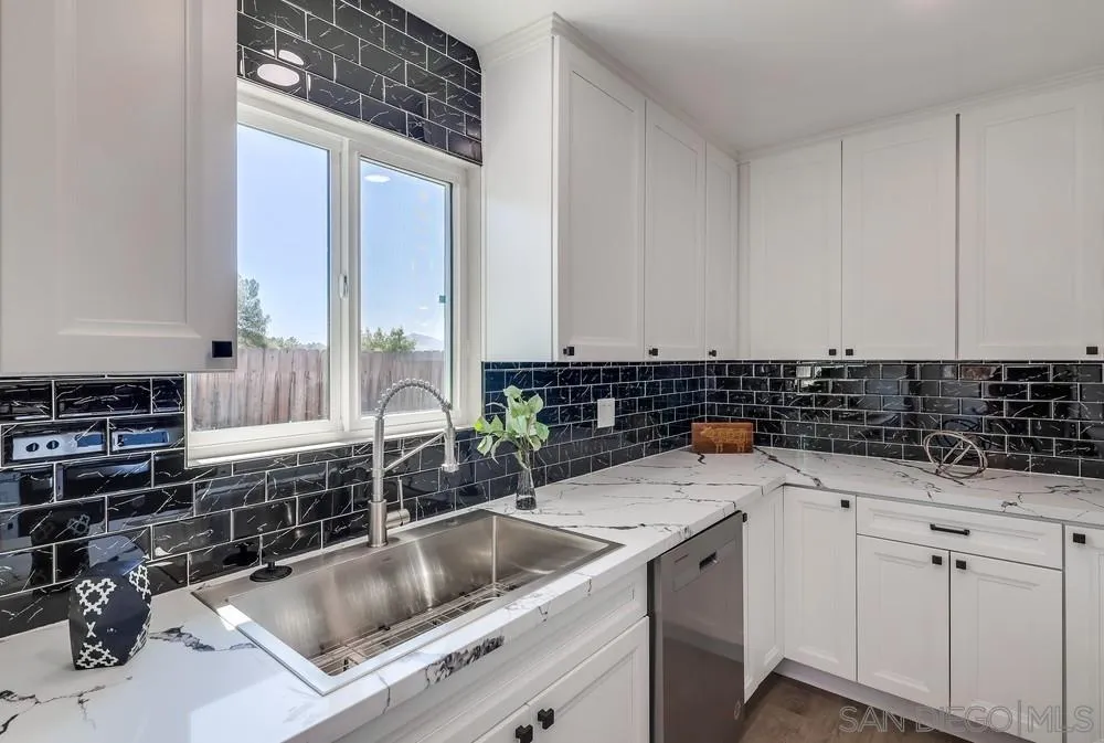9136 Northcote Road Santee, CA 92071 - Photo 3 of 33 a kitchen with a sink and cabinets