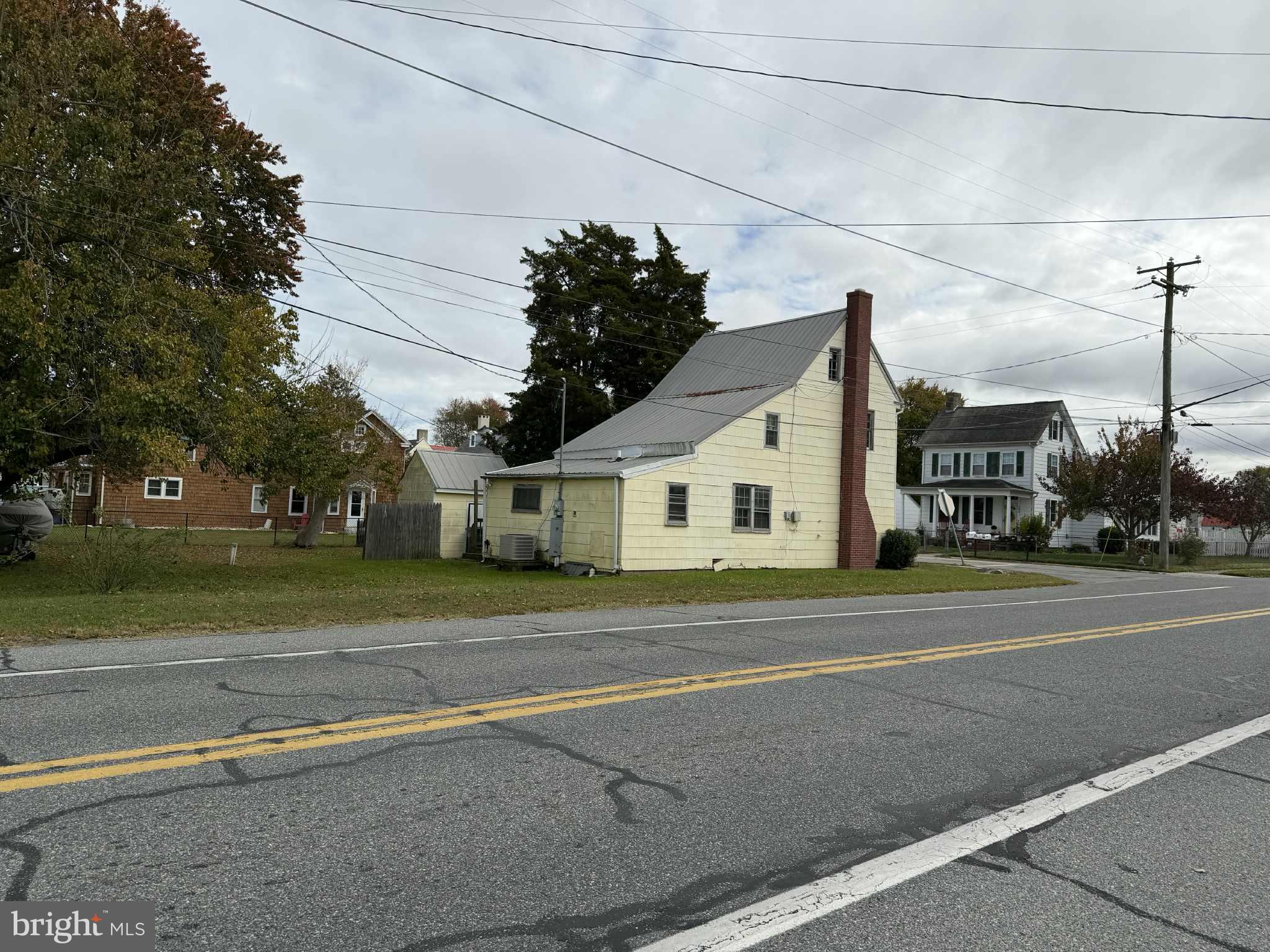 181 Front Street Dover, DE 19901 - Photo 2 of 6 a view of a white house next to a road and yard