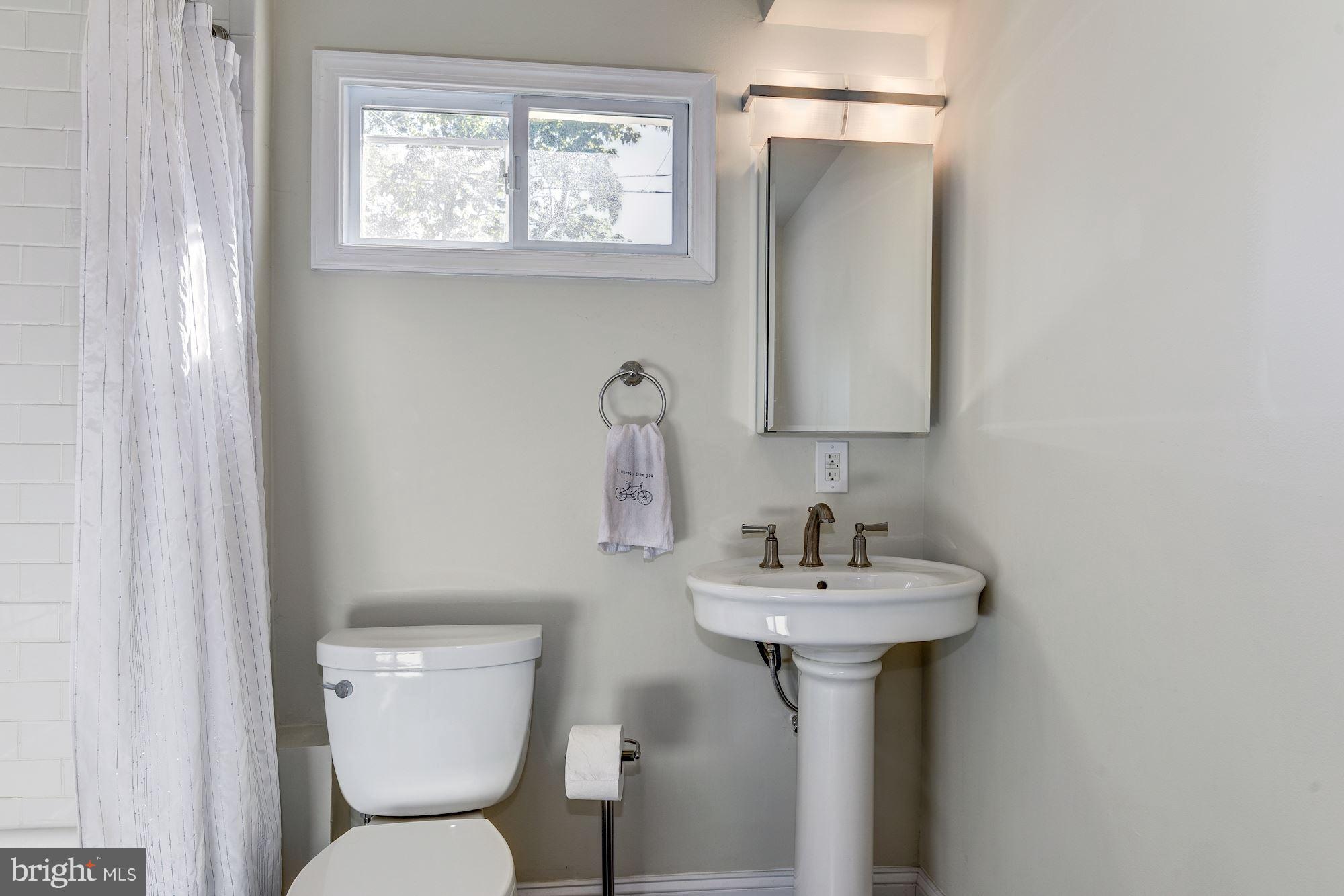 908 Pendleton Street Alexandria, VA 22314 - Photo 11 of 22 a bathroom with a sink toilet and a mirror