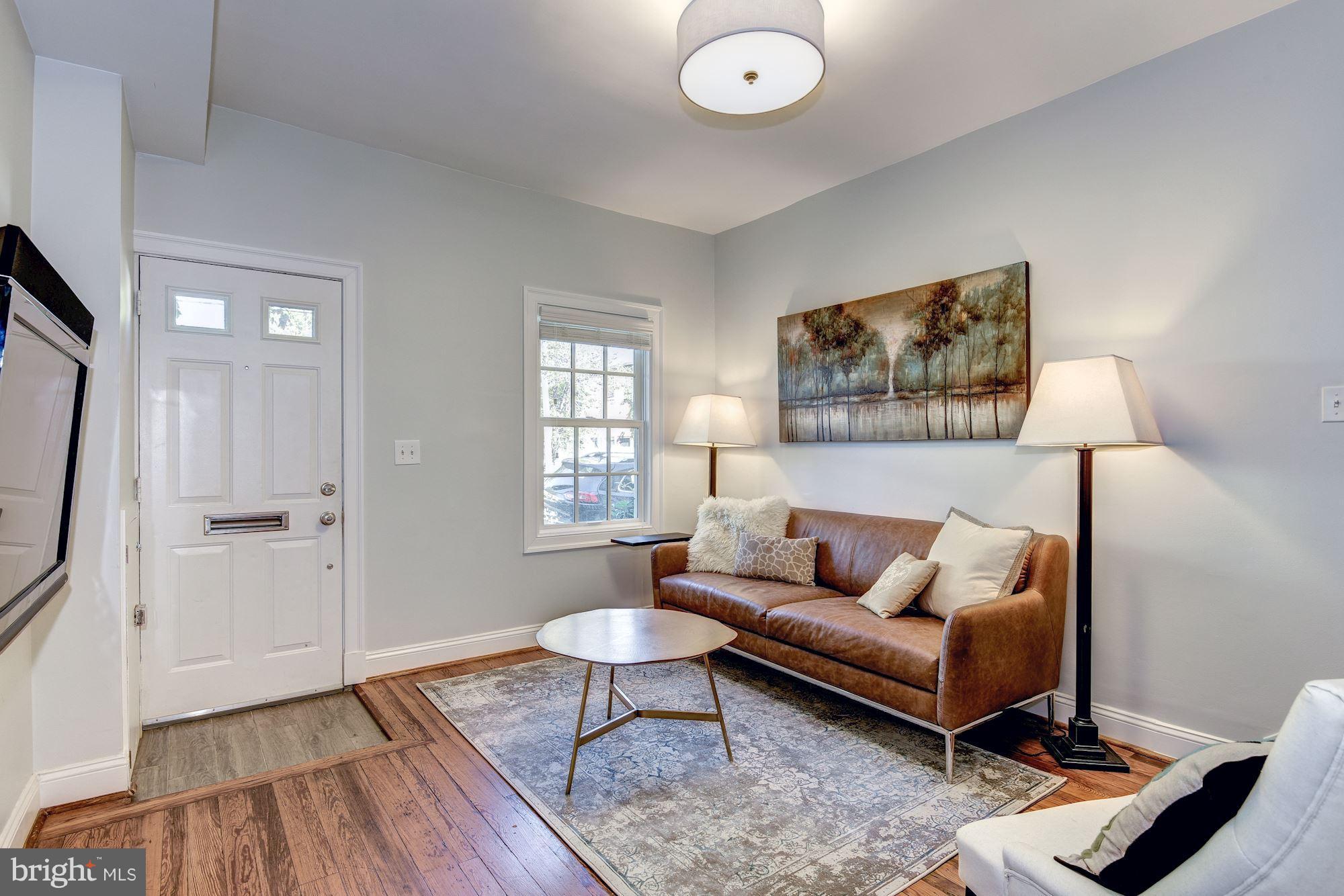 908 Pendleton Street Alexandria, VA 22314 - Photo 3 of 22 a living room with furniture and a flat screen tv