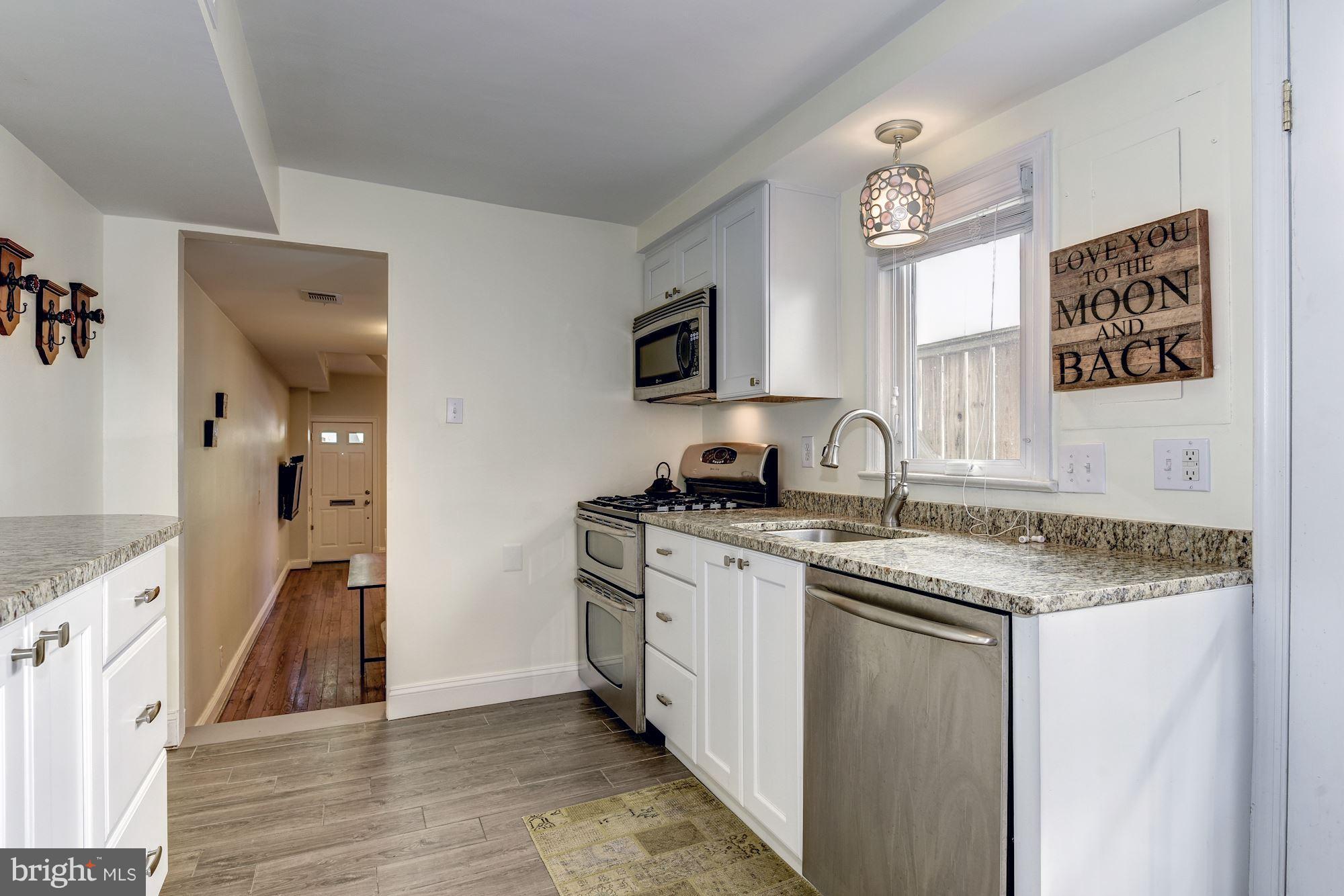 908 Pendleton Street Alexandria, VA 22314 - Photo 10 of 22 a kitchen with stainless steel appliances granite countertop a sink stove and refrigerator