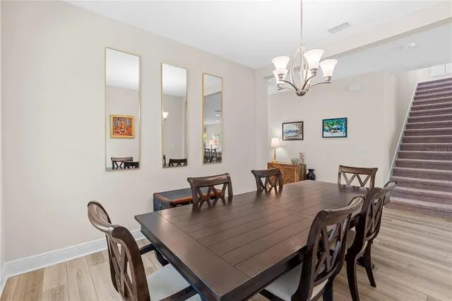 a kitchen with stainless steel appliances a stove a sink a refrigerator white cabinets and a refrigerator