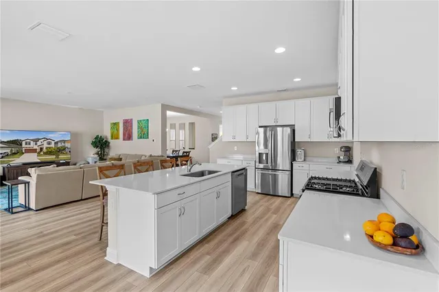 a living room with furniture and kitchen view