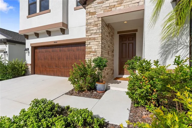 a view of a living hall with wooden floor and a flat screen tv