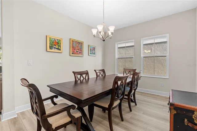 a view of a dining room with furniture and chandelier