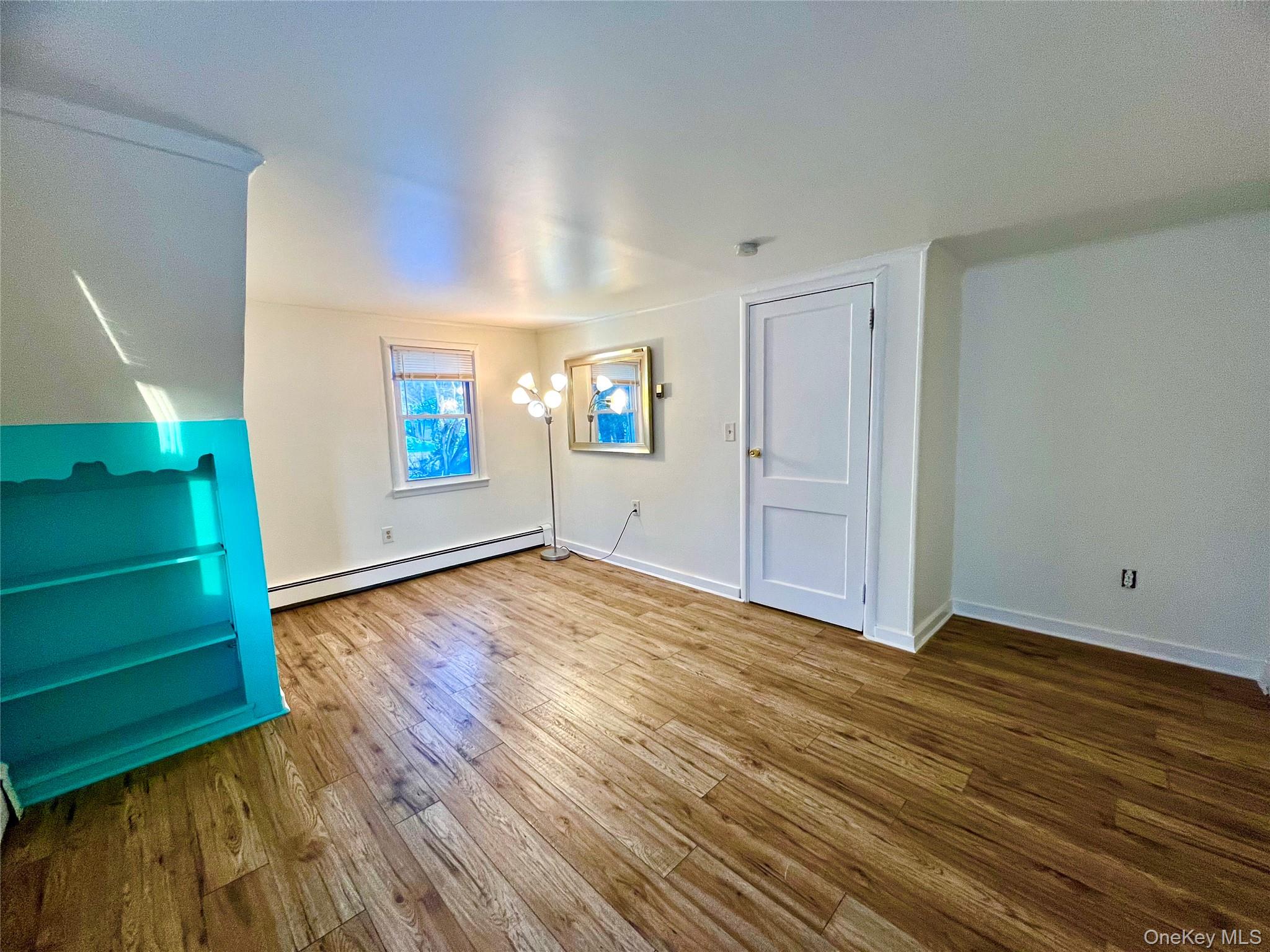 23 Independence Avenue Middletown, NY 10940 - Photo 24 of 35 an empty room with wooden floor stairs and windows