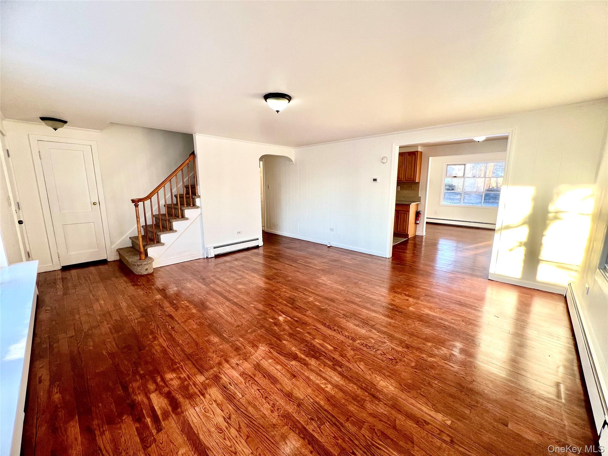 23 Independence Avenue Middletown, NY 10940 - Photo 4 of 35 a view of an empty room with wooden floor and stairs
