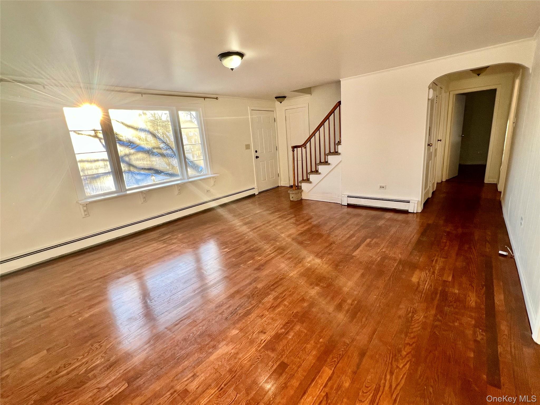 23 Independence Avenue Middletown, NY 10940 - Photo 5 of 35 an empty room with wooden floor and windows