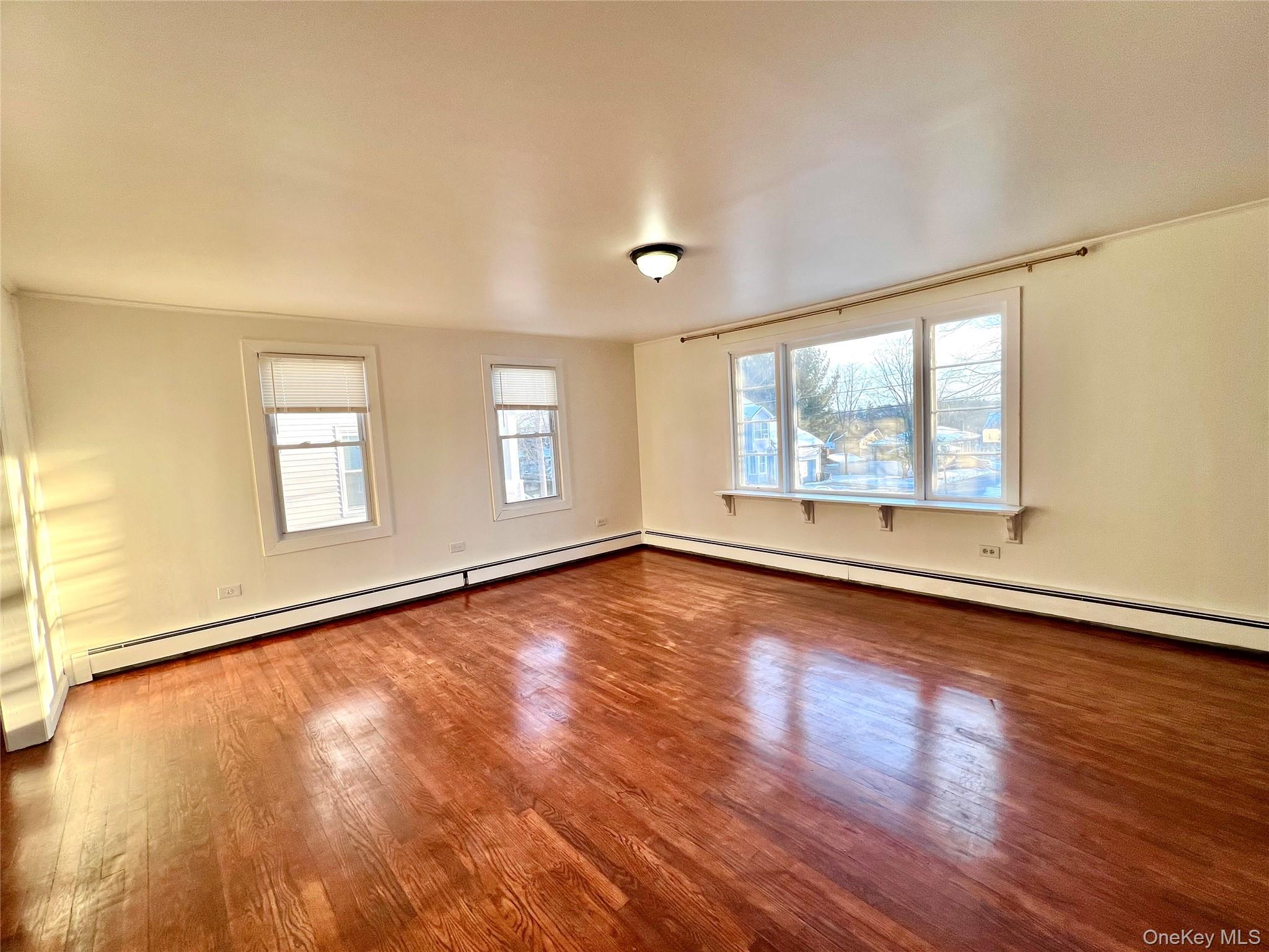 23 Independence Avenue Middletown, NY 10940 - Photo 6 of 35 a view of an empty room with wooden floor and a window