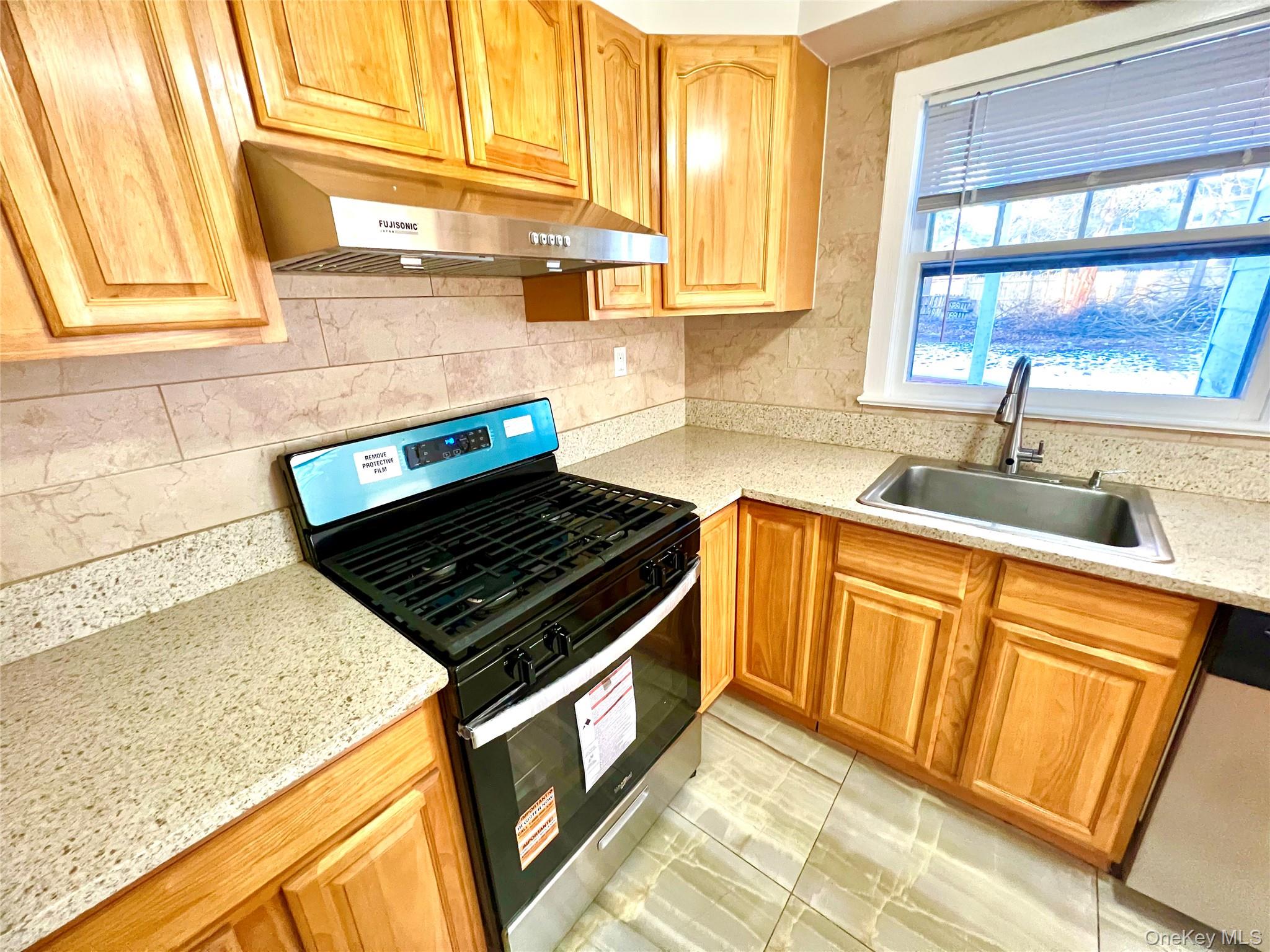 23 Independence Avenue Middletown, NY 10940 - Photo 10 of 35 a kitchen with granite countertop wooden cabinets a sink and a window