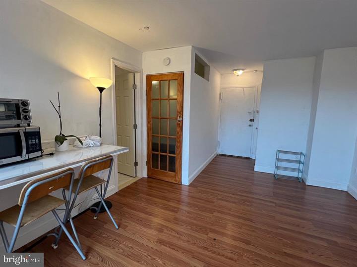 1121 Arlington Boulevard, Unit 947 Arlington, VA 22209 - Photo 5 of 11 a view of a room with wooden floor furniture and windows