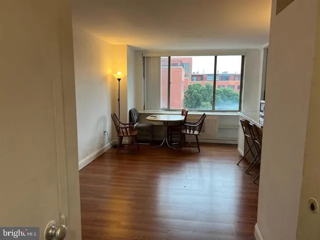 a view of a workspace with furniture and a window