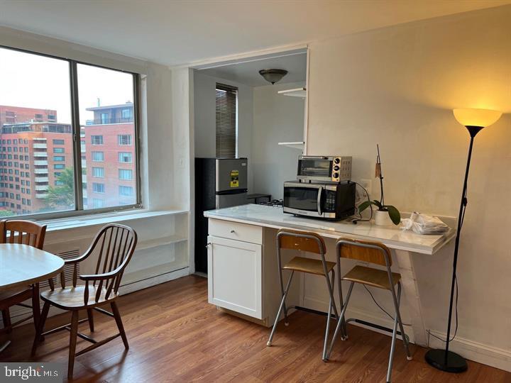 1121 Arlington Boulevard, Unit 947 Arlington, VA 22209 - Photo 7 of 11 a view of a workspace with furniture and a window
