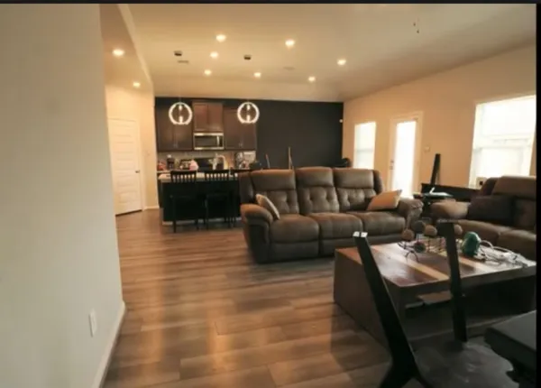 a view of kitchen with stainless steel appliances granite countertop a stove a sink and a microwave
