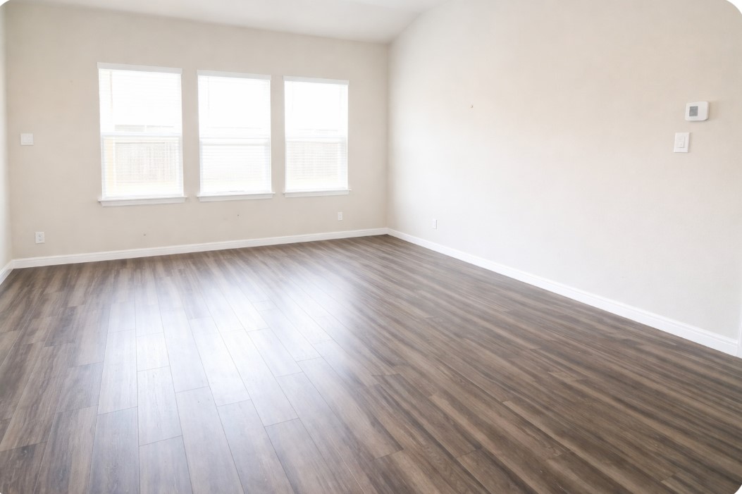 10831 Sugar Pne Lane Rosharon, TX 77583 - Photo 7 of 23 an empty room with wooden floor and windows