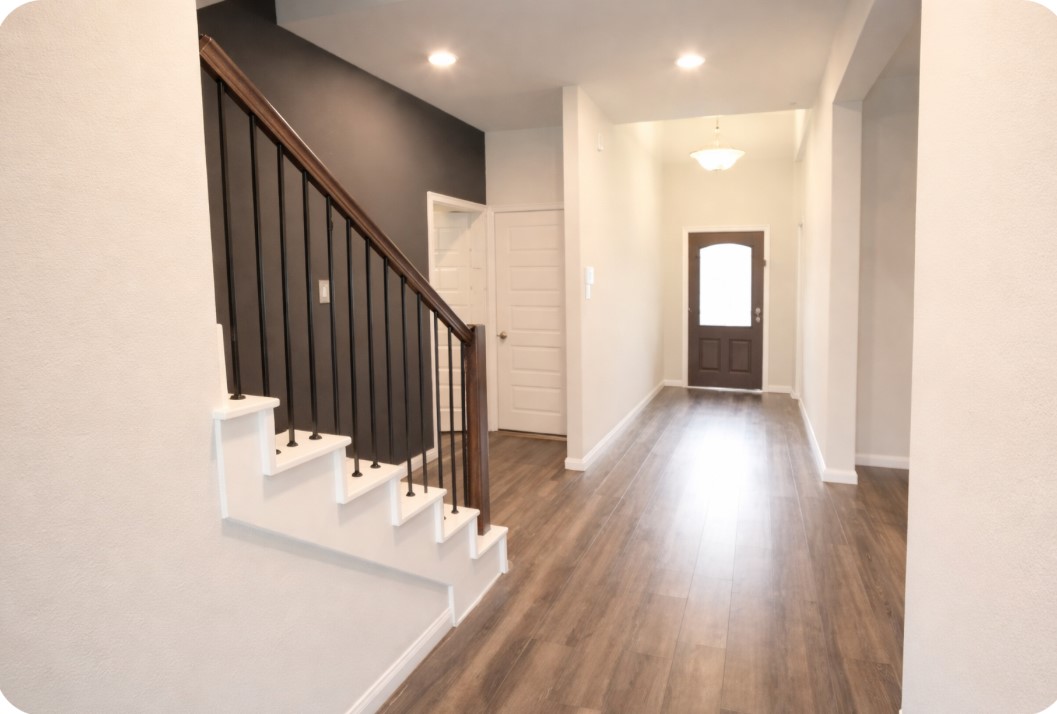 10831 Sugar Pne Lane Rosharon, TX 77583 - Photo 10 of 23 a view of a hallway view with wooden floor and staircase