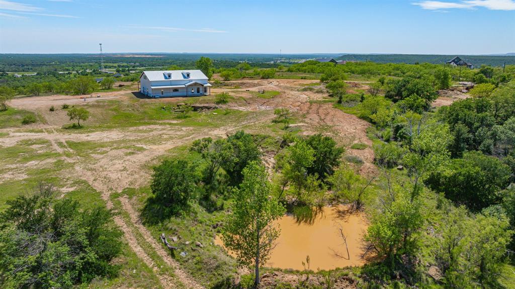 467 Weatherby Way Santo, TX 76472 - Photo 18 of 28 a backyard of a house with a yard and lake view