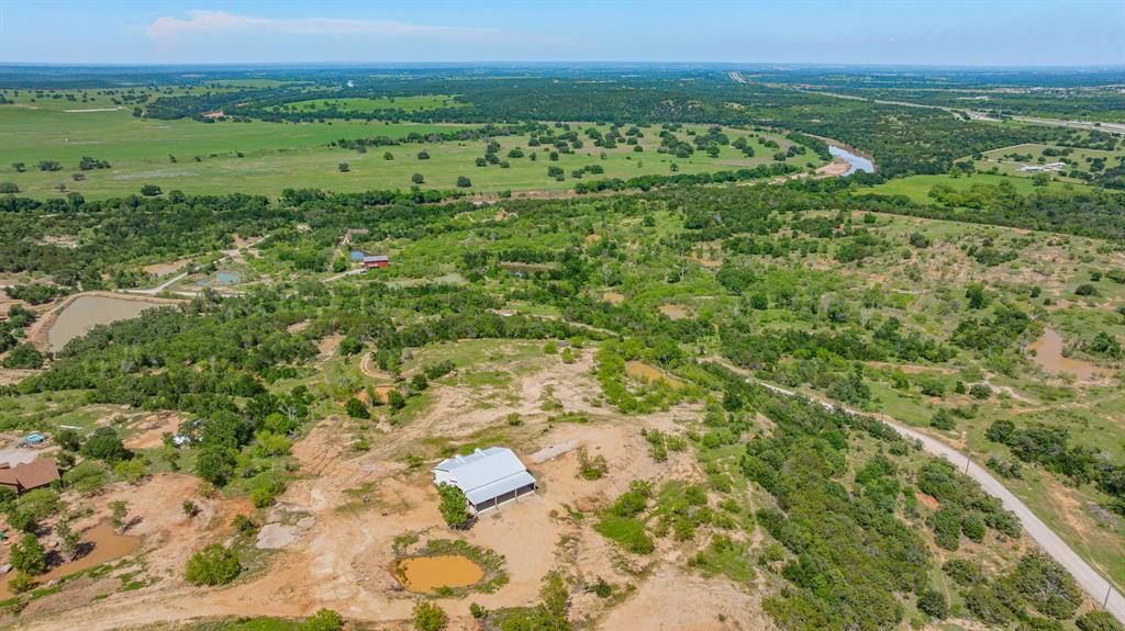 467 Weatherby Way Santo, TX 76472 - Photo 24 of 28 a view of a green field with lots of trees