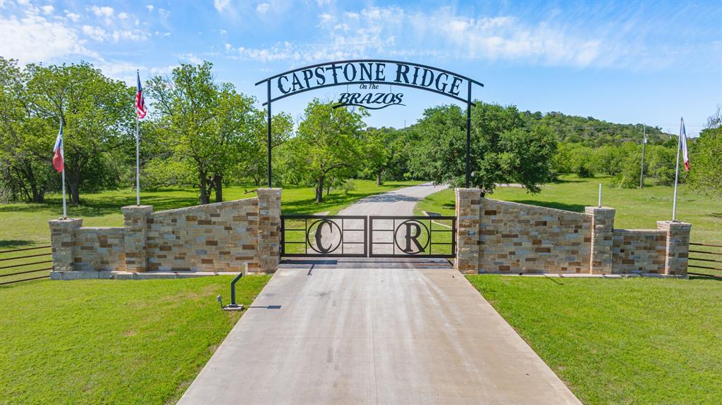 467 Weatherby Way Santo, TX 76472 - Photo 27 of 28 a view of a park with large trees and a wooden fence