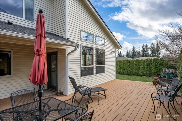 a view of a house with backyard and sitting area
