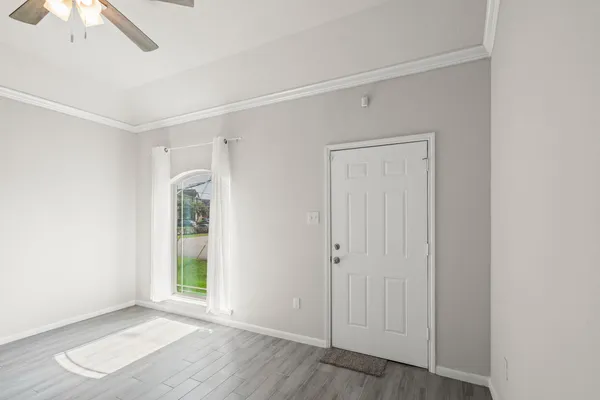 an empty room with windows and closet