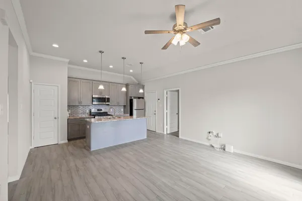 a view of kitchen and kitchen with stove top oven