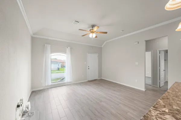 wooden floor in an empty room with a window