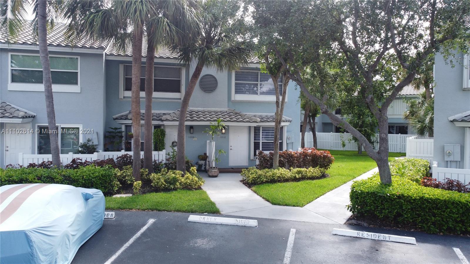 1010 Jeffery Street, Unit 1010 Boca Raton, FL 33487 - Photo 3 of 9 a front view of a house with garden and trees