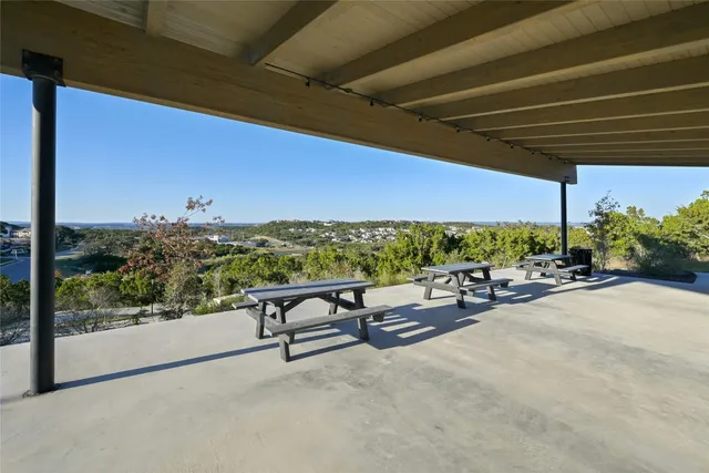 a view of a patio with a table chairs and couches under an umbrella