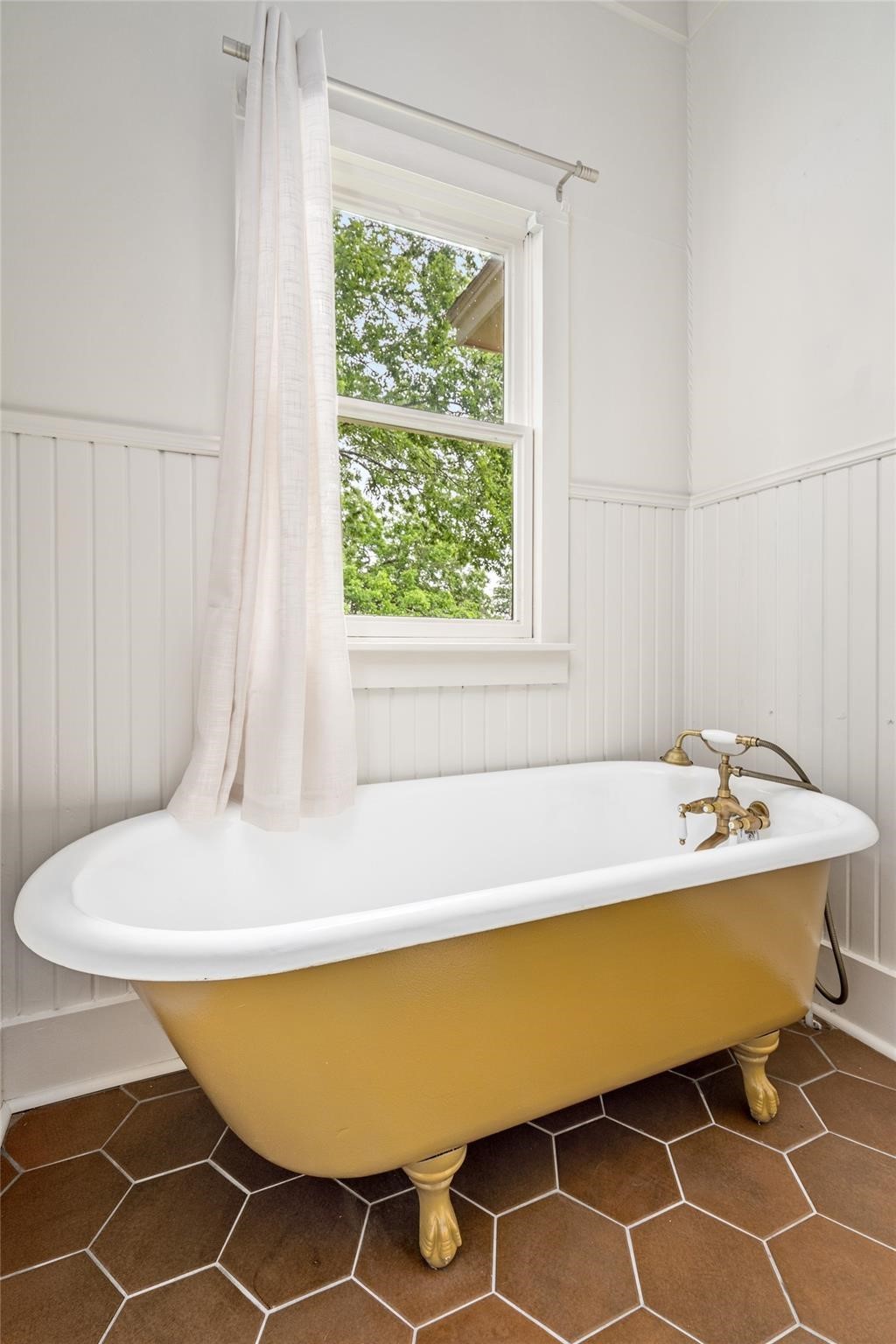 806 East Main Street Bellville, TX 77418 - Photo 30 of 38 a bath tub sitting in a bathroom next to a window