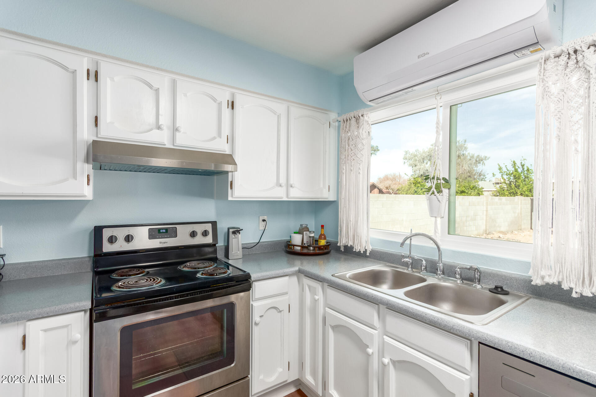 4826 West Wagoner Road Glendale, AZ 85308 - Photo 11 of 26 a kitchen with granite countertop a sink stove top oven and cabinets