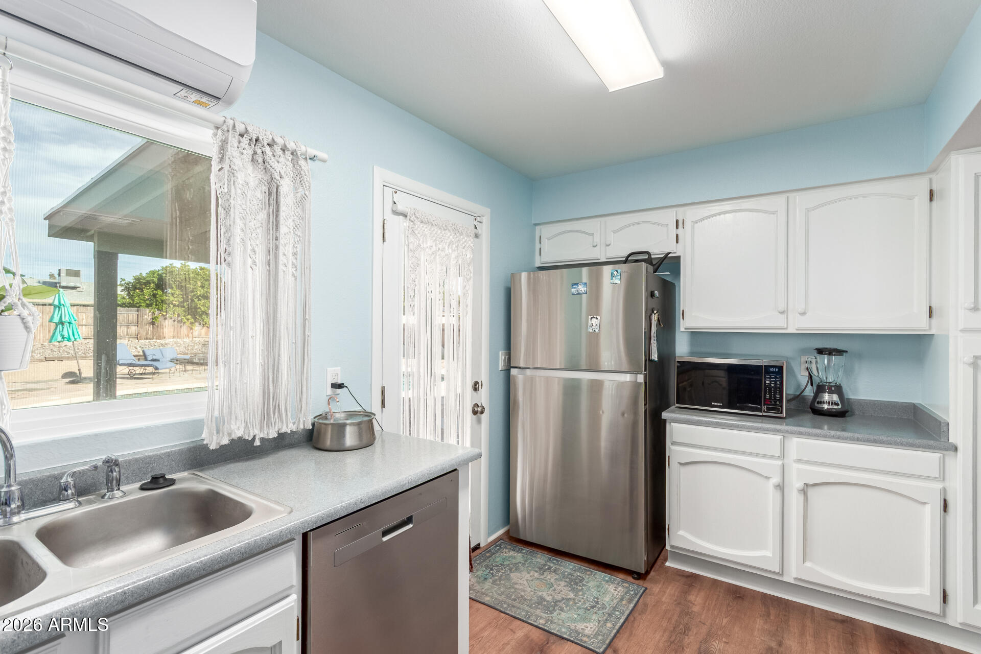 4826 West Wagoner Road Glendale, AZ 85308 - Photo 12 of 26 a kitchen with white cabinets sink and refrigerator